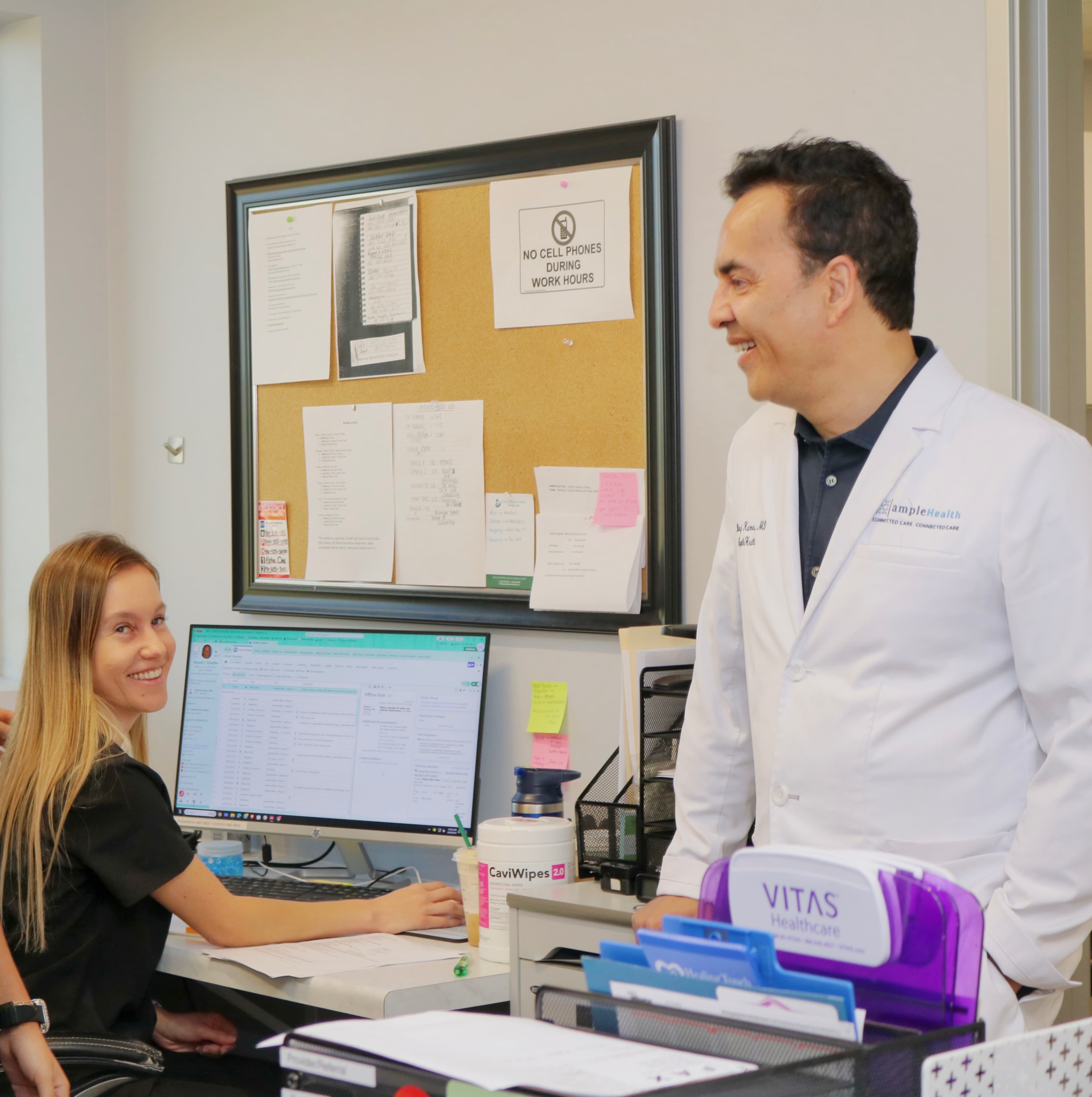 Dr. Kamra catching up with a member of the care team