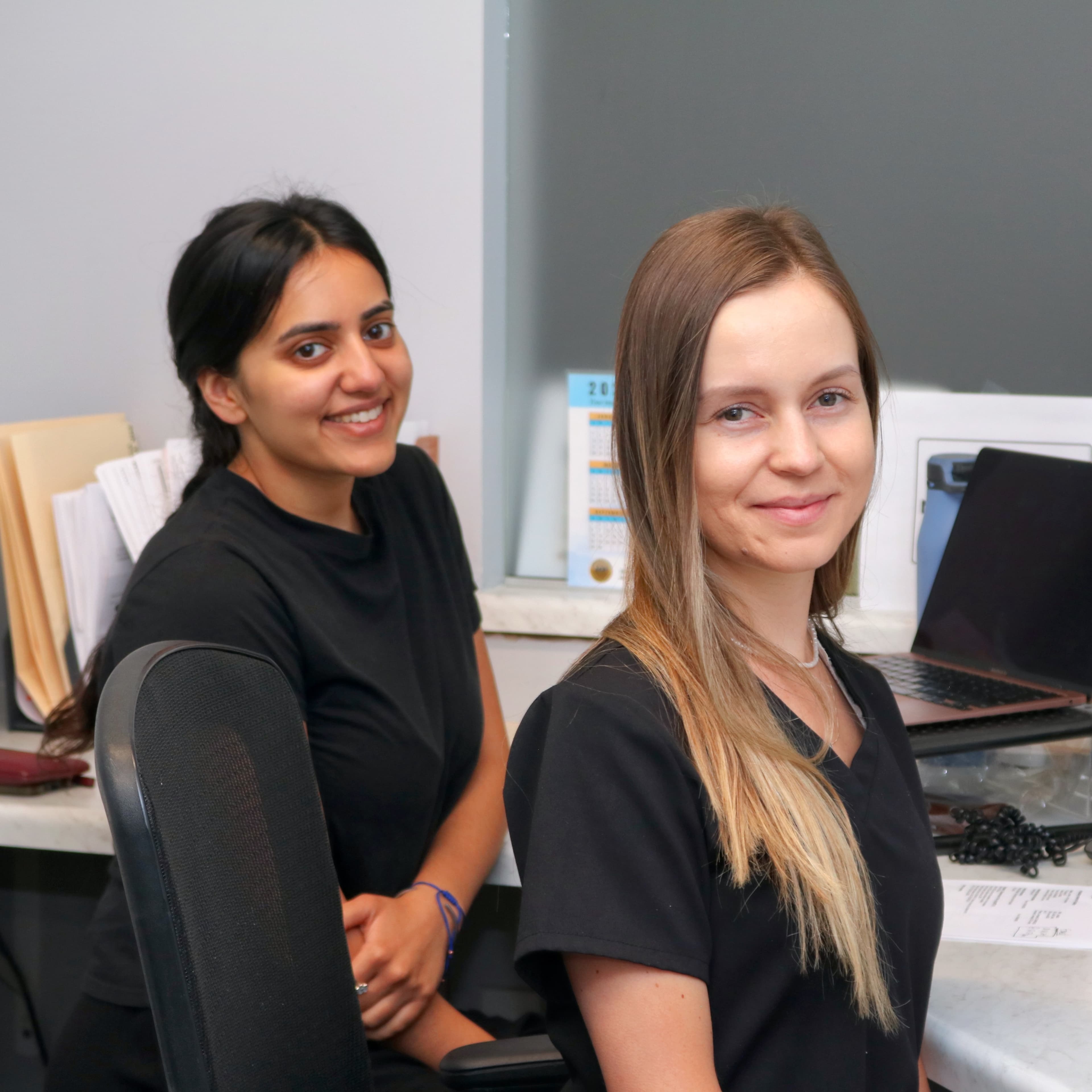 Shreya and Liana at the front desk